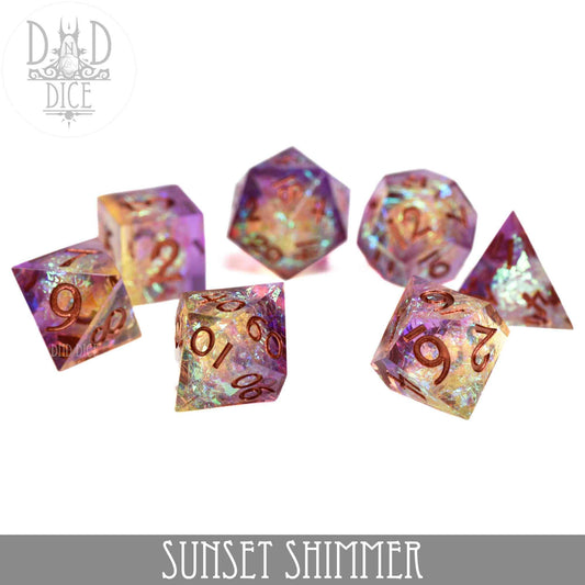 Seven colorful, iridescent Sunset Shimmer handmade resin dice on a white background.