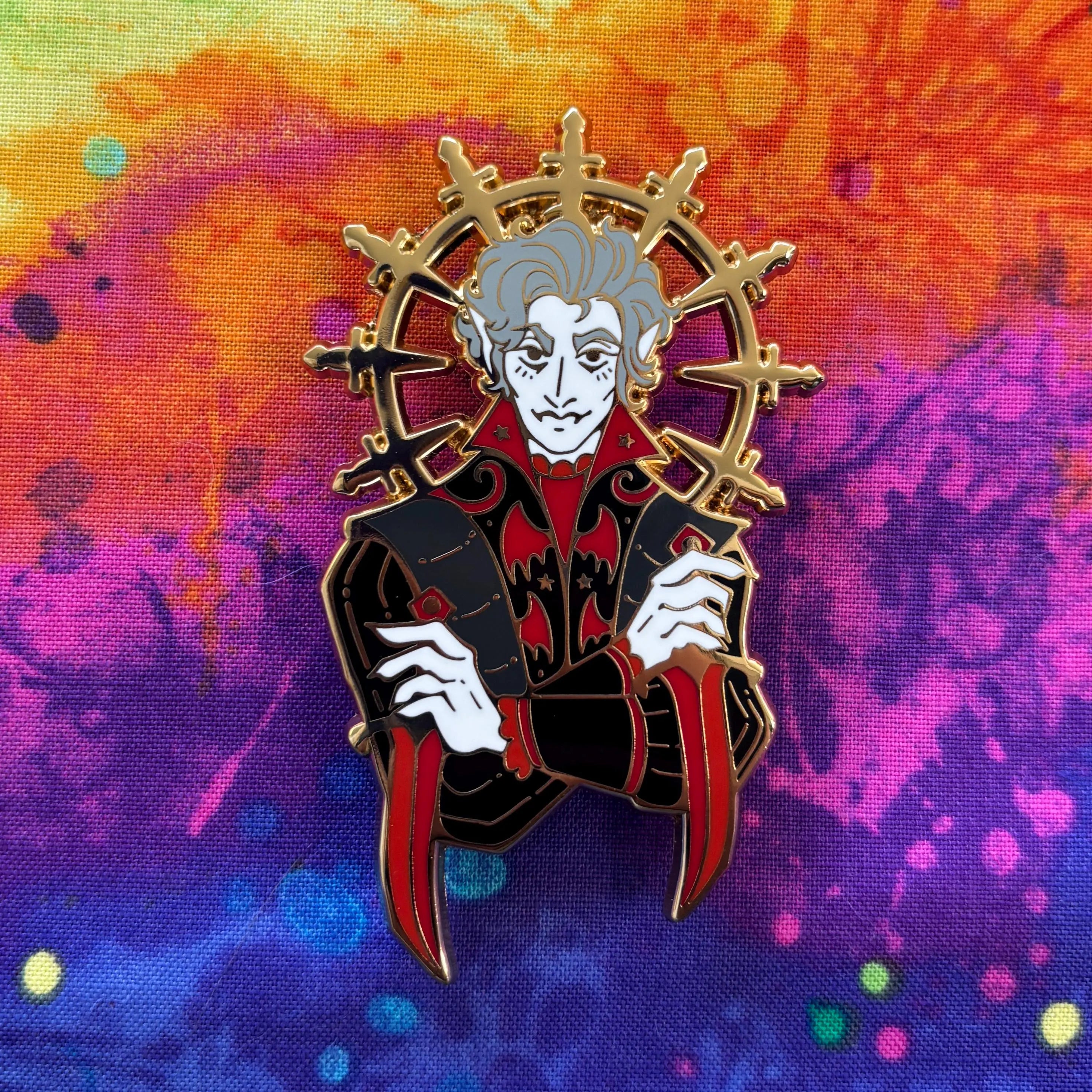 Astarion enamel pin featuring a vampire with a gold halo, gothic clothing, and daggers.