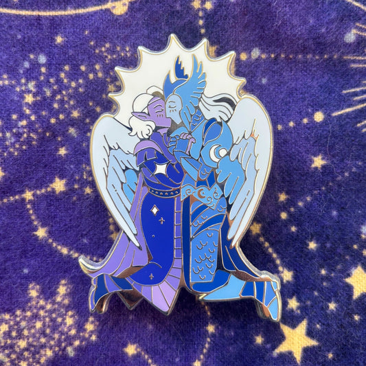 The Aylin and Isobel Pin featuring two armored, winged figures embracing under a starry purple sky.
