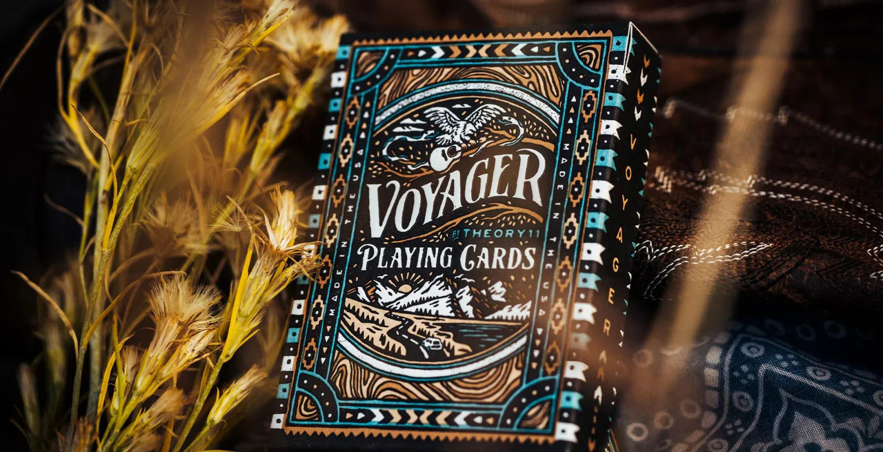 Voyager Playing Cards displayed on cloth beside dried grass and plants.