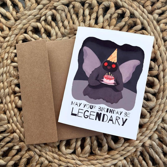 Birthday card with Mothman in a party hat and cake, captioned May your birthday be legendary.