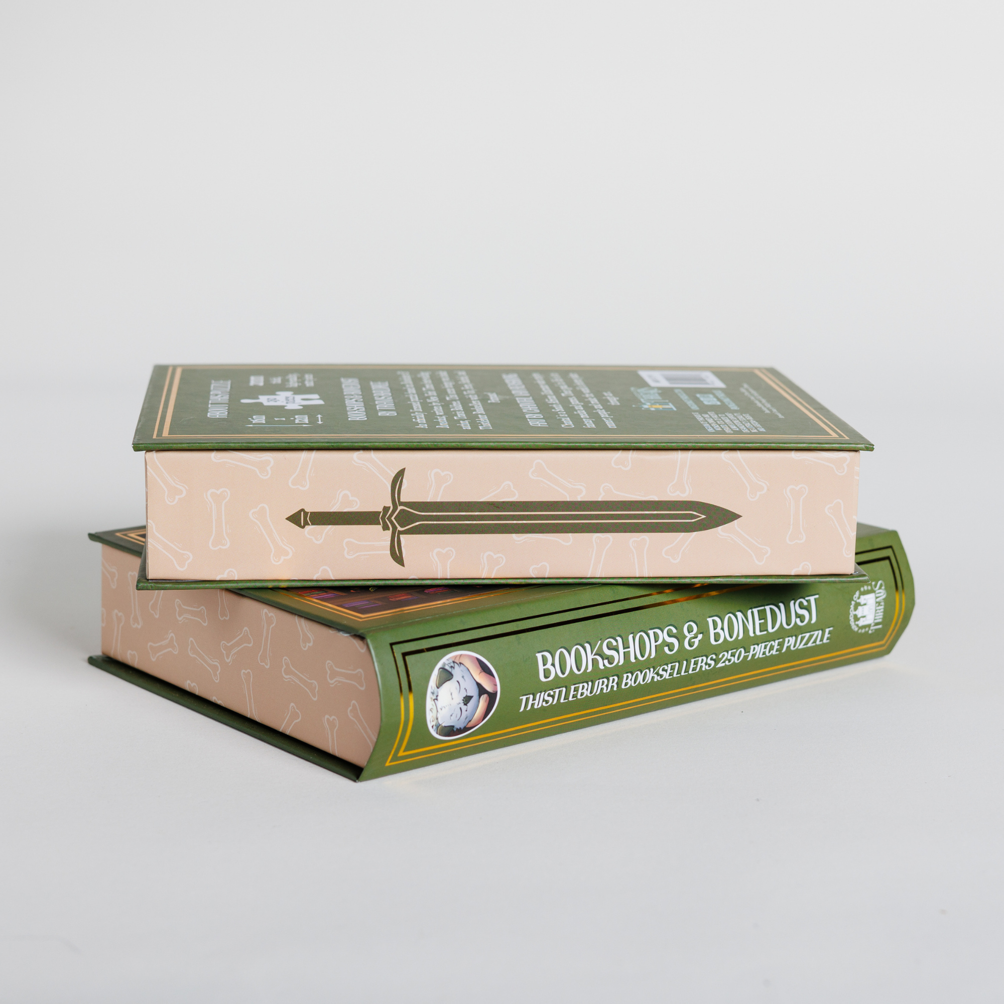 Two Thistleburr Bookshop Keepsake Puzzle boxes, one stacked flat and one on its side, both in book-style packaging.