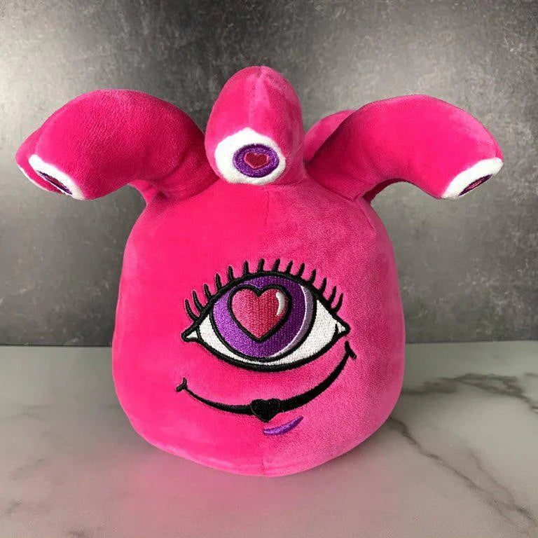 Ella the Eyegor plush, bright pink with three tentacles, three eyes, and a heart-shaped pupil.