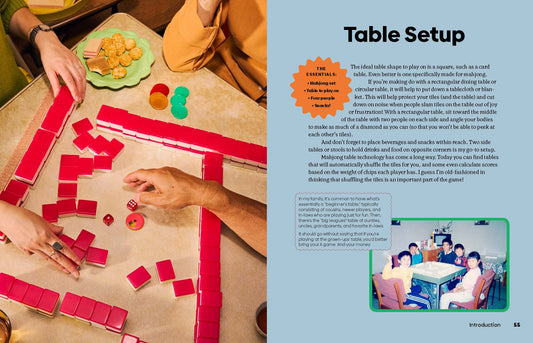 Families playing Mahjong together, with snacks on the table. Mahjong game set in use.