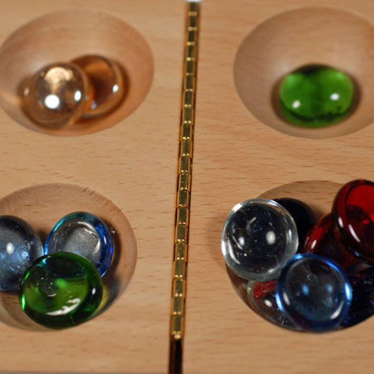 Assorted replacement glass mancala stones for mancala boards.