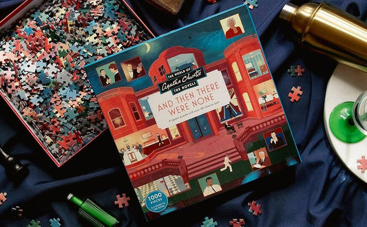 The World of Agatha Christie: And Then There Were None Puzzle with pieces scattered on a blue cloth.