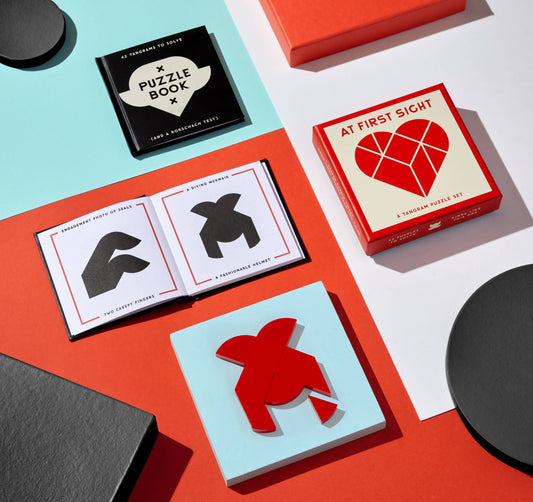 Brass Monkey At First Sight Tangram Puzzle with heart-shaped designs on geometric backgrounds.