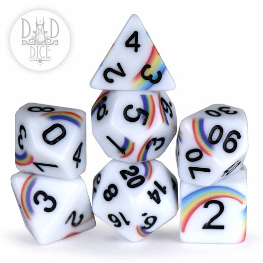 Rainbow Doodles 7-piece acrylic dice set with black engraved numbers and rainbow designs, loosely stacked.