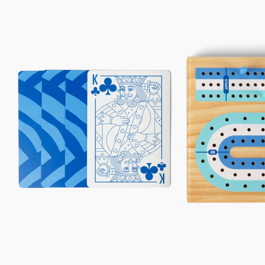 Canvas Classics Cribbage set with pegs, shown beside three blue playing cards and a King of Clubs.