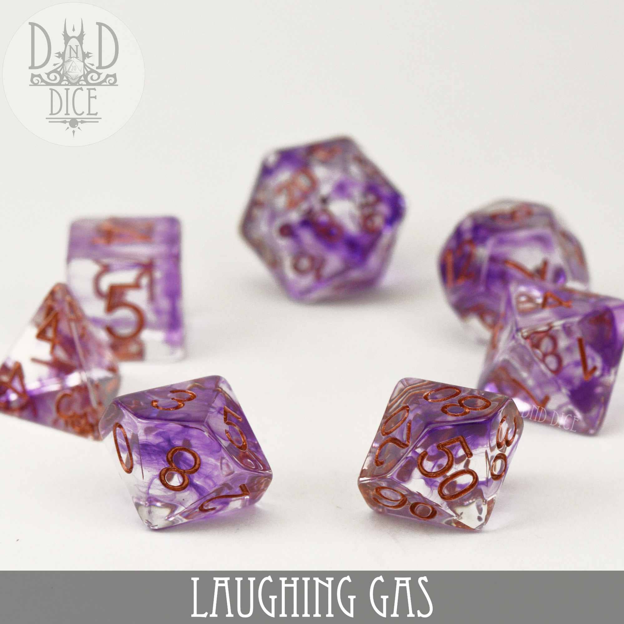 Set of seven translucent purple resin Laughing Gas dice with copper numbers on a white surface.