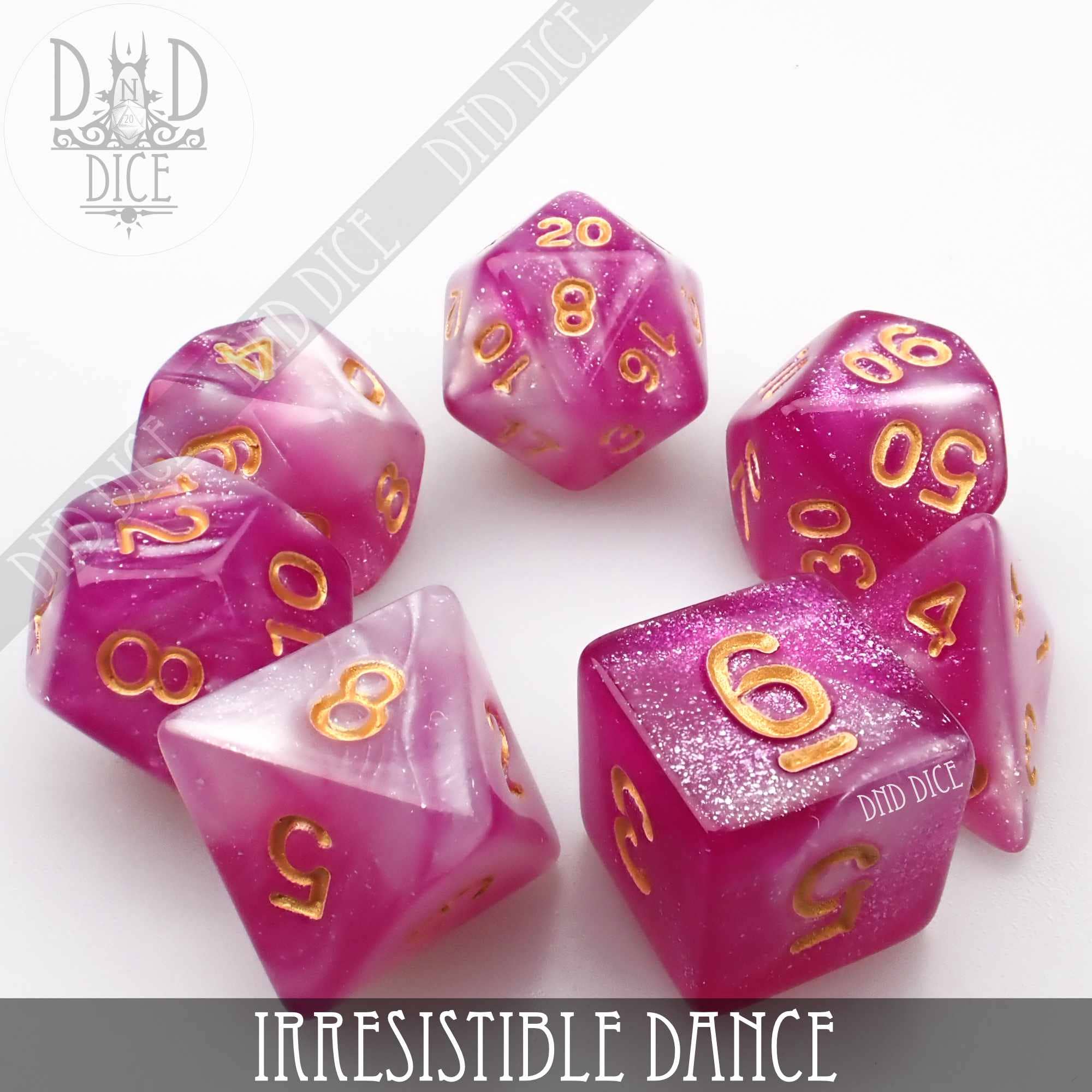 Pink and white acrylic dice set with gold numbers, Irresistible Dance variant by DnD Dice.