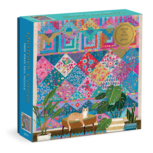 Victoria Ball Quilter’s Corner 1000 Piece Foil Puzzle featuring a cat on bench, vibrant quilt, and green plants.