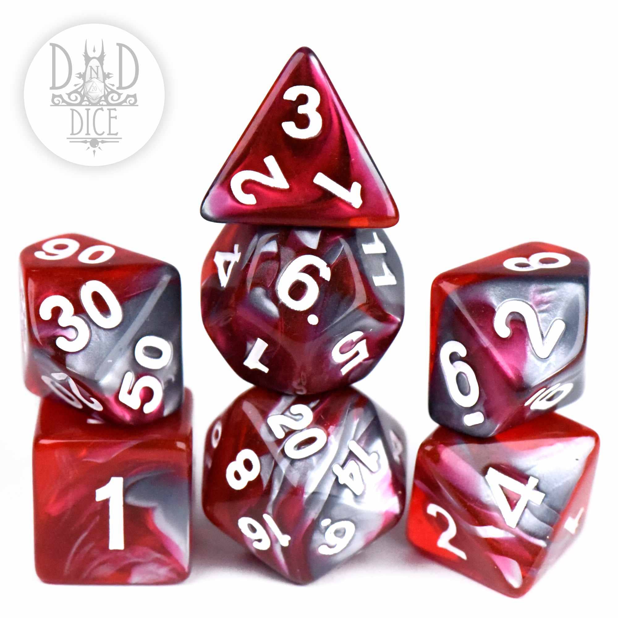 Six Steel and Blood dice in red and black marbled acrylic with white numbers, pyramid stacked.