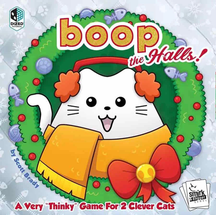 Boop the Halls: 2-player holiday board game featuring a white cartoon cat in earmuffs and a scarf sitting in a wreath.