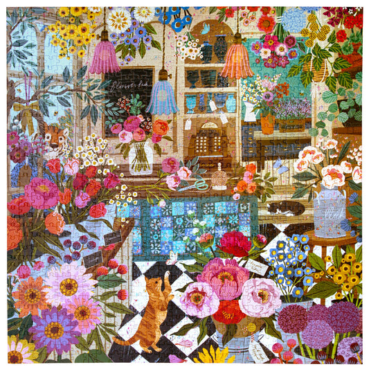 The English Flower Shop 1000 Piece Puzzle with colorful flowers, hanging lamps, cat, and scattered papers.