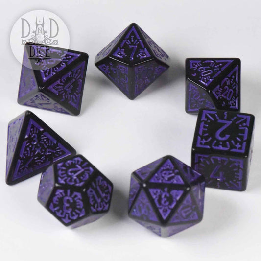 Lunar Eclipse, set of seven black and purple ornate acrylic tabletop gaming dice on a white surface.