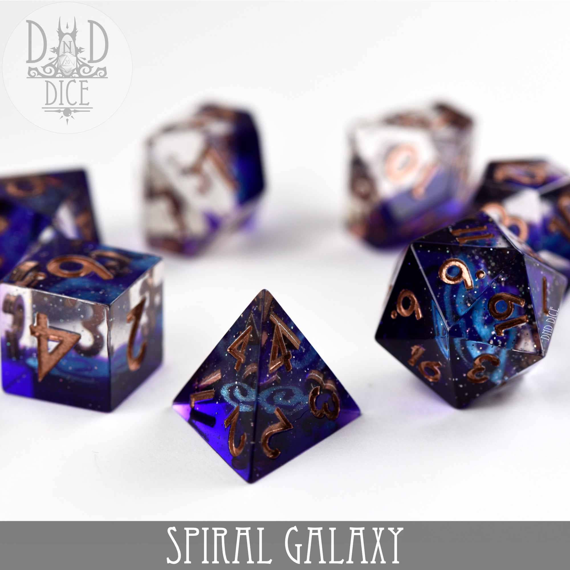 Spiral Galaxy Handmade 7-piece dice set, purple and clear resin with gold numbers.