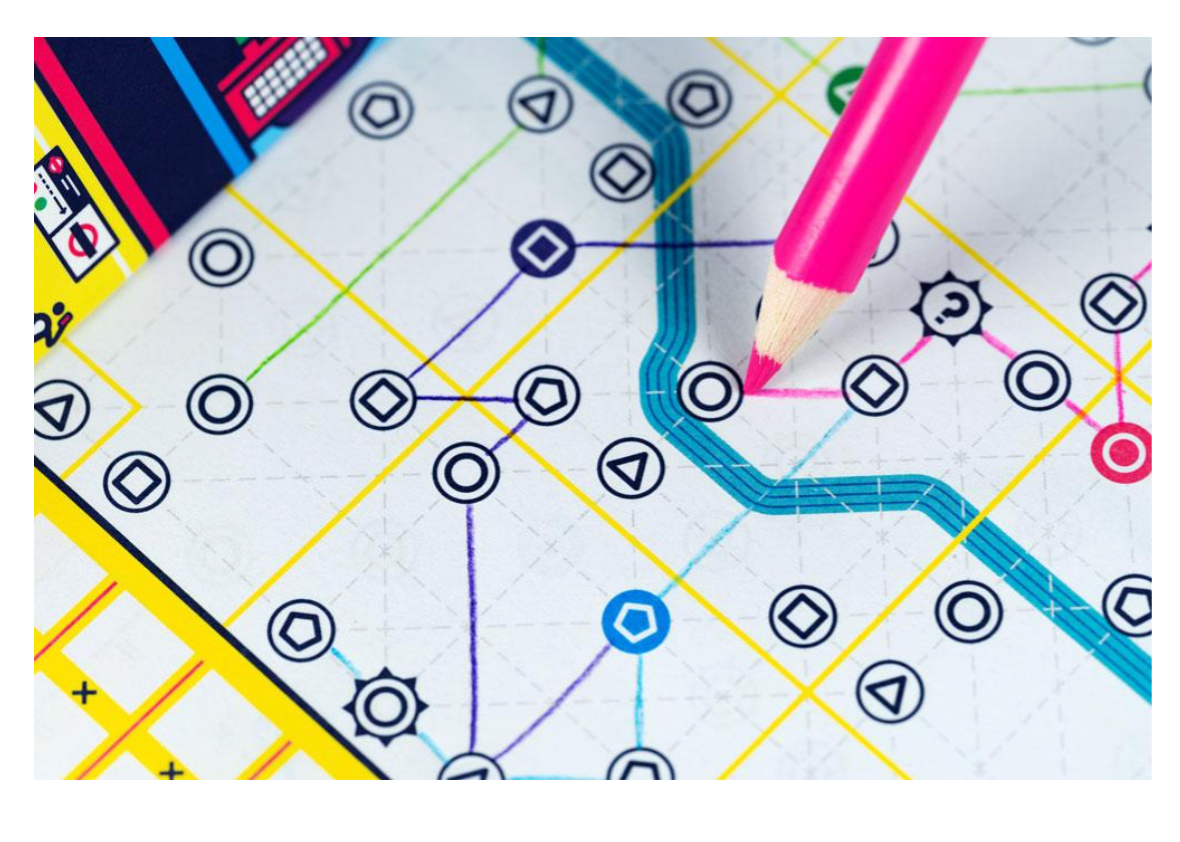 Next Station London board game with geometric game board and a pink pencil pointing at it.