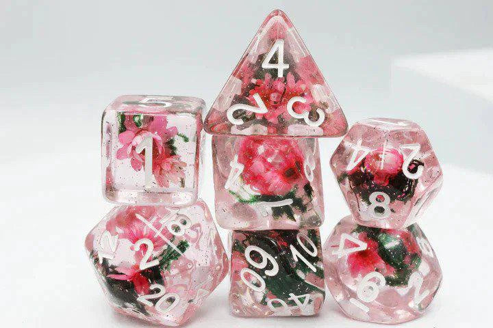 Carnation Love RPG Dice Set—clear polyhedral dice with white numbers and a pink flower inside each die.