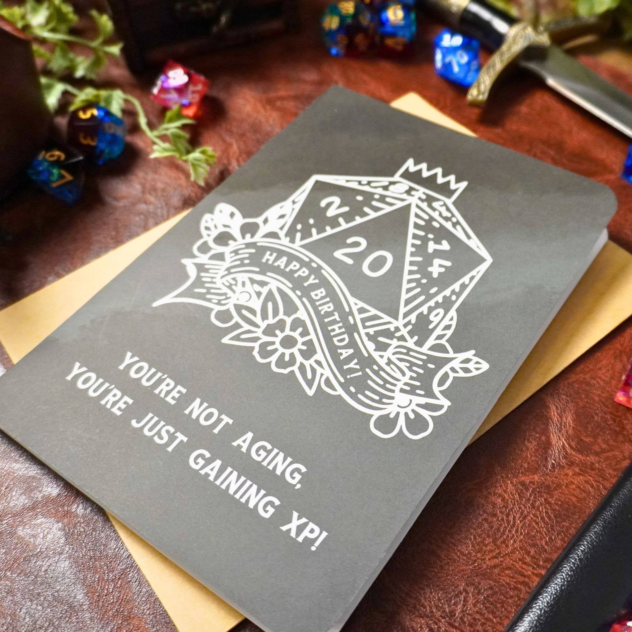 Youre Not Aging XP DnD Birthday Card with D20 dice and text: Youre not aging, youre just gaining XP.
