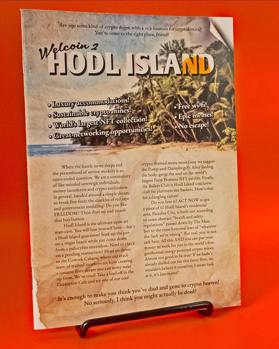 Troika Adventure: Hodl Island brochure displayed upright on a black holder.