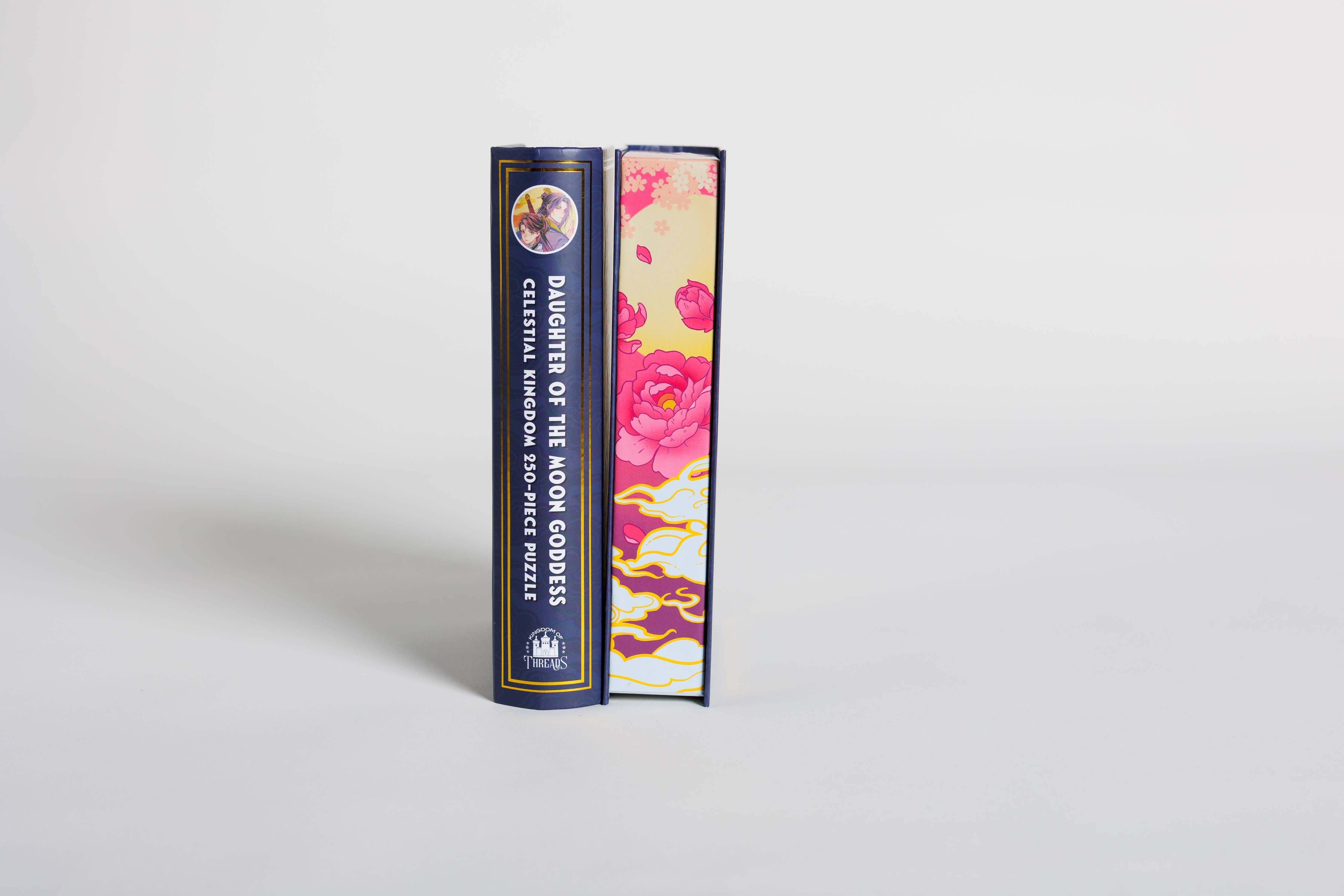 Daughter of the Moon Goddess Keepsake Puzzle and floral book-shaped keepsake box, both upright.
