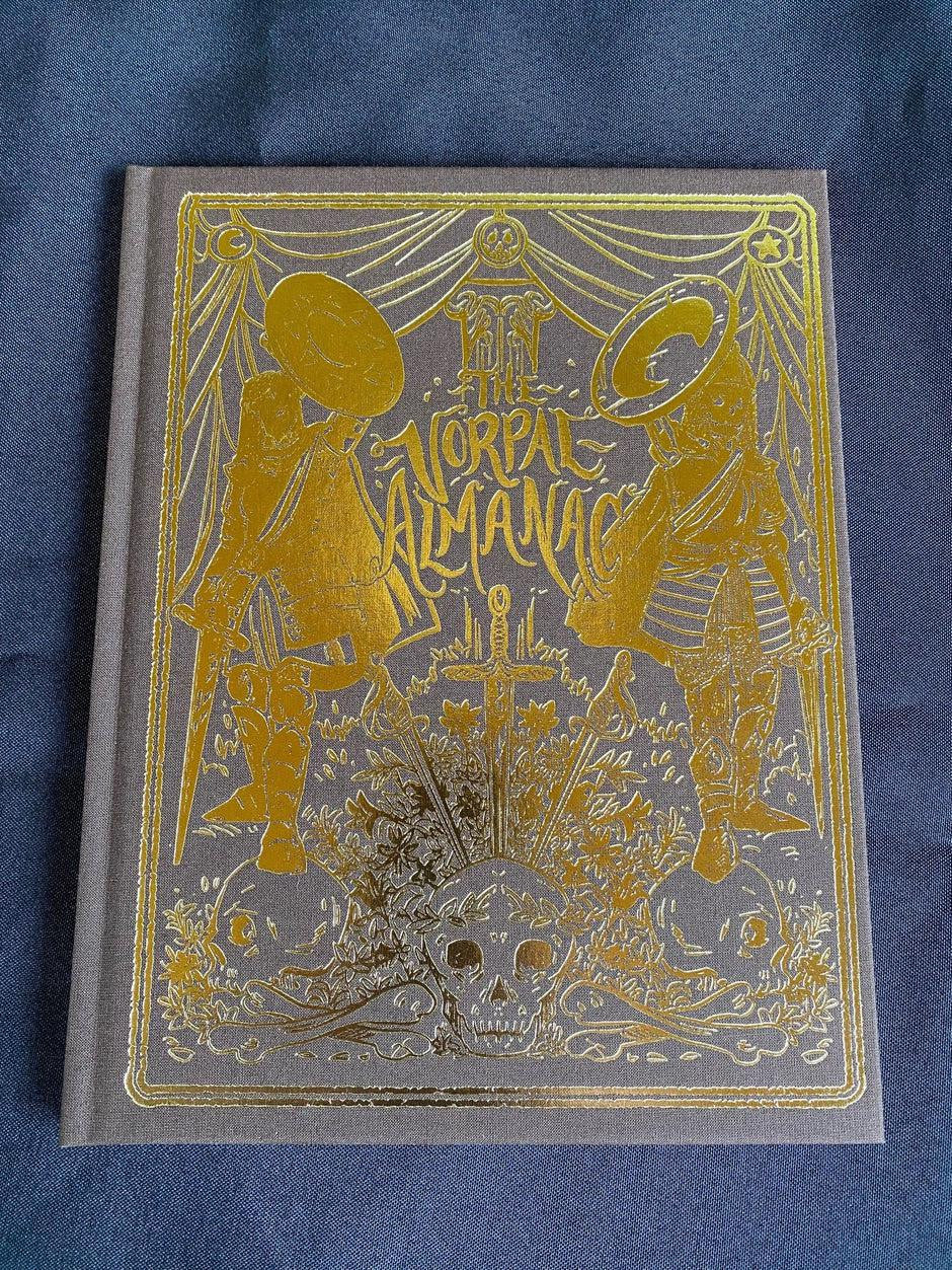 Vorpal Almanac book cover featuring gold illustrations of two helmeted figures and eldritch swords.