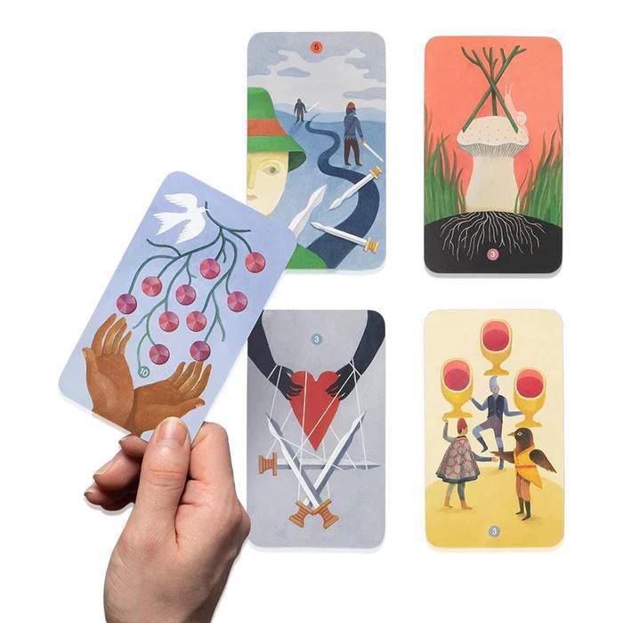 Tarot for All Ages (Deck) card held in hand; four additional beginner cards on a white surface.