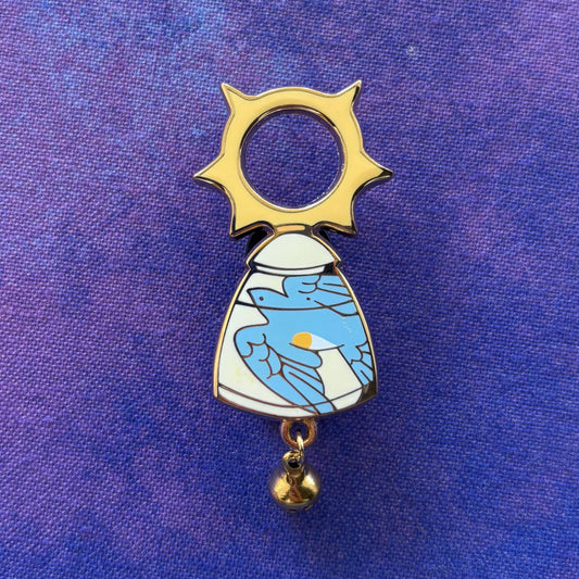 D&D Class Curiosities pin featuring a stylized angel with sun halo, blue wings, and gold bell.