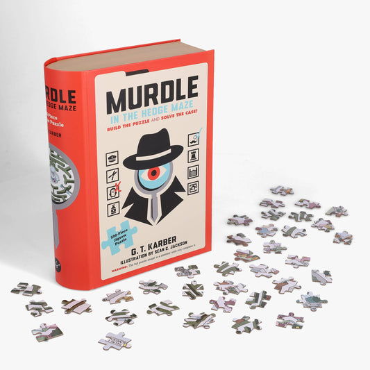 Murdle in the Hedge Maze 500-piece jigsaw puzzle next to its book with pieces scattered on a white background.