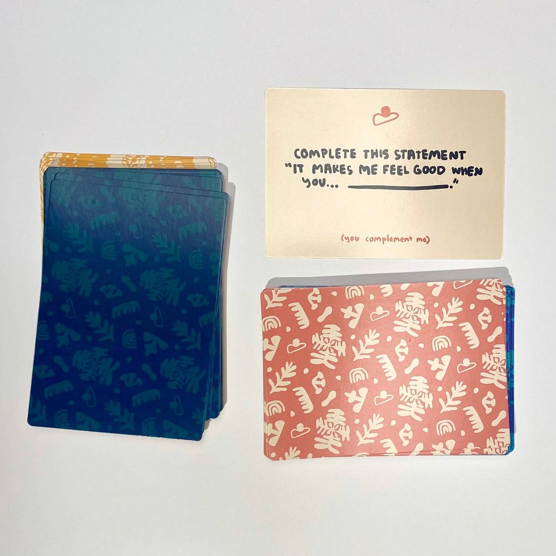 A Safe Space For Us Deck prompt card reads: It makes me feel good when you… with relationship prompts.
