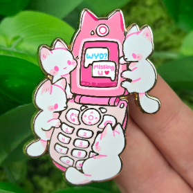 Pink flip phone enamel pin featuring five white kittens.