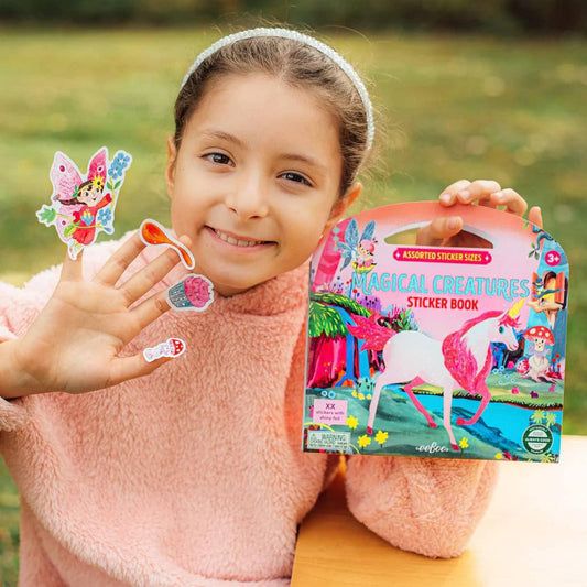 Magical Creatures Shiny Sticker Book with unicorn design, shown by a girl displaying related stickers on her hand.