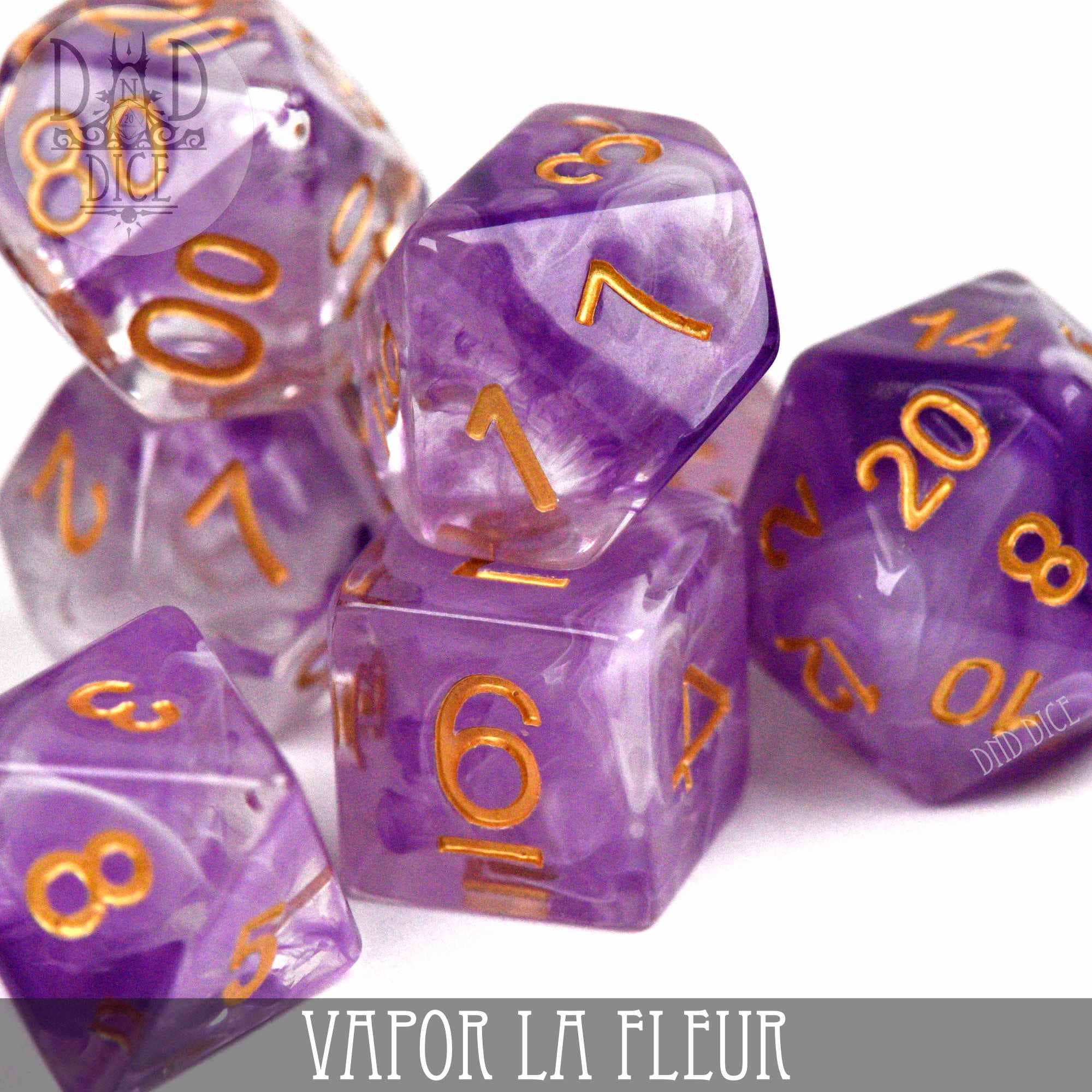 Vapor La Fleur 7-dice set for tabletop gaming, made of purple and clear resin with gold numbers.