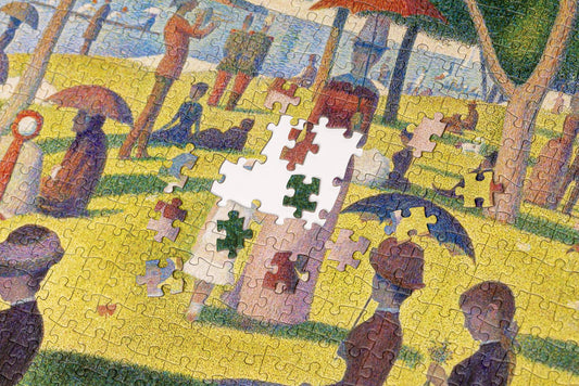 Partially assembled Georges Seurat Sunday Afternoon puzzle with several pieces missing in the center.