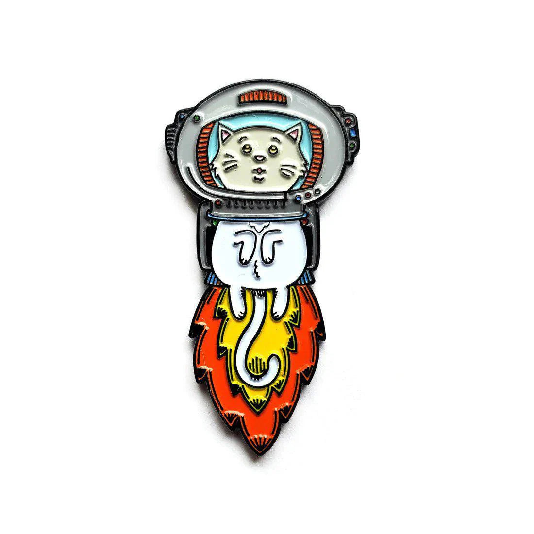 Kolorspun Astrokitty enamel pin featuring a white cartoon space cat on a rocket with orange-yellow flames on a white background.