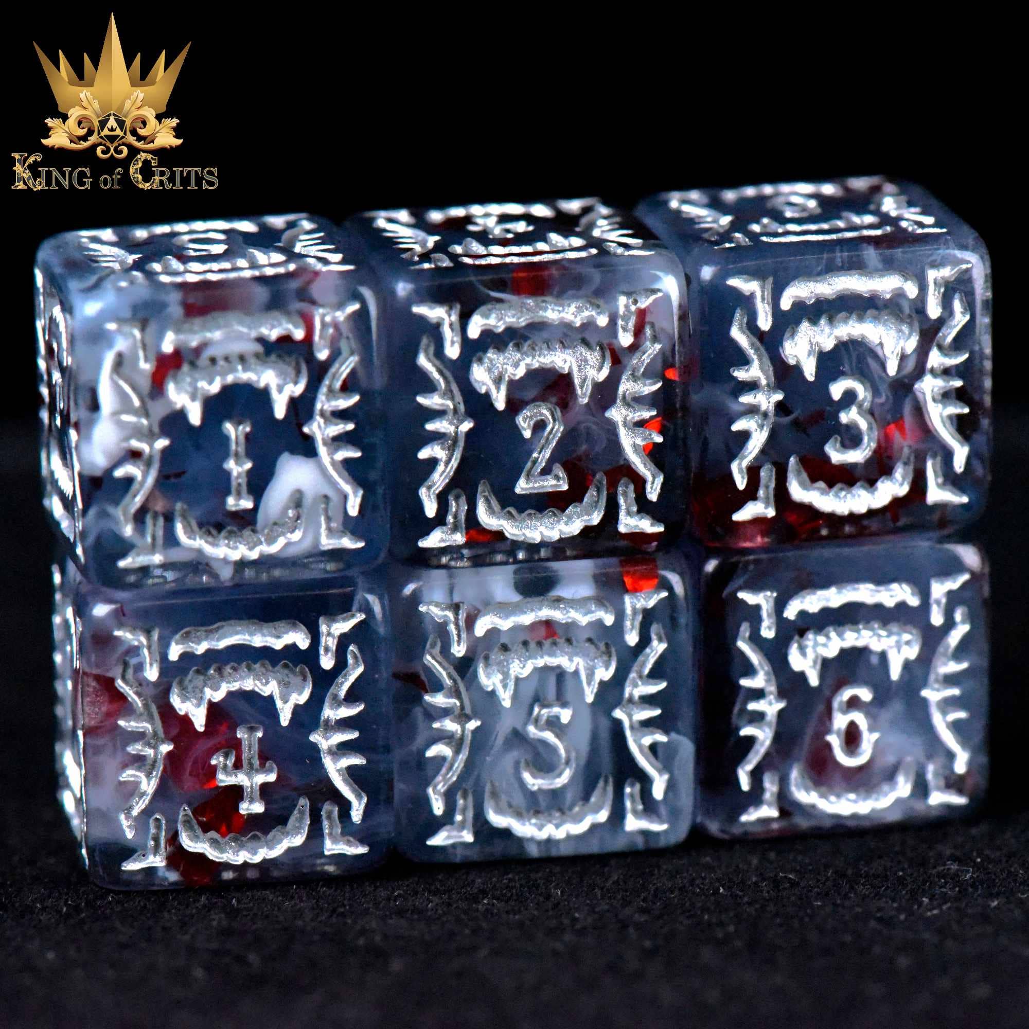 The Vampiric Bloodline 11 Dice Set with translucent dice and white fanged designs.