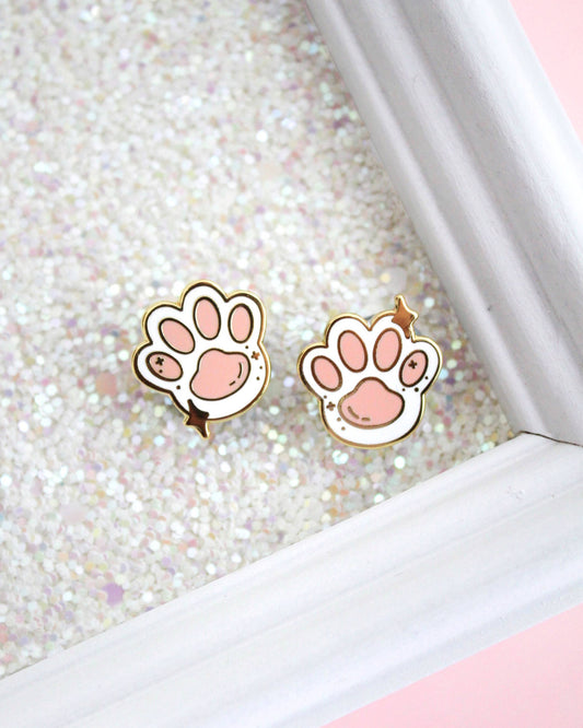 Two Toe Beans enamel pins in pink and white with gold outlines.