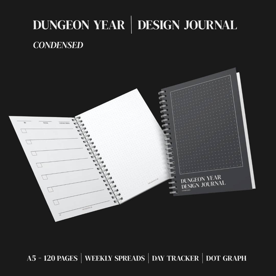 Two Dungeon Year Design Journal spiral notebooks; one is open displaying dot grid pages.