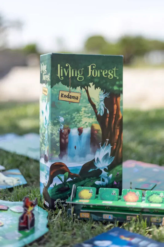 Living Forest Kodama Expansion box with game cards and pieces arranged on grass.