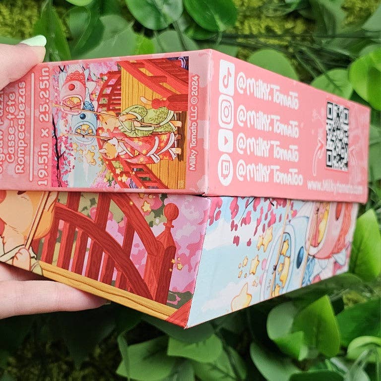 Kimono Kitties 500-Piece Puzzle box held in a hand, with anime-style art on the cover.