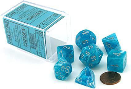 Cirrus® Polyhedral Aqua/silver 7-Die Set next to a penny and an open Chessex clear plastic box.