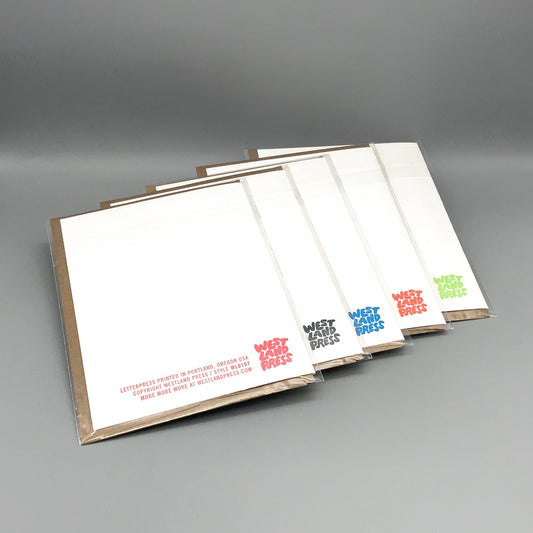 Miss Hanging white notecards with colored logos, in sets of five, each paired with recycled kraft envelopes.