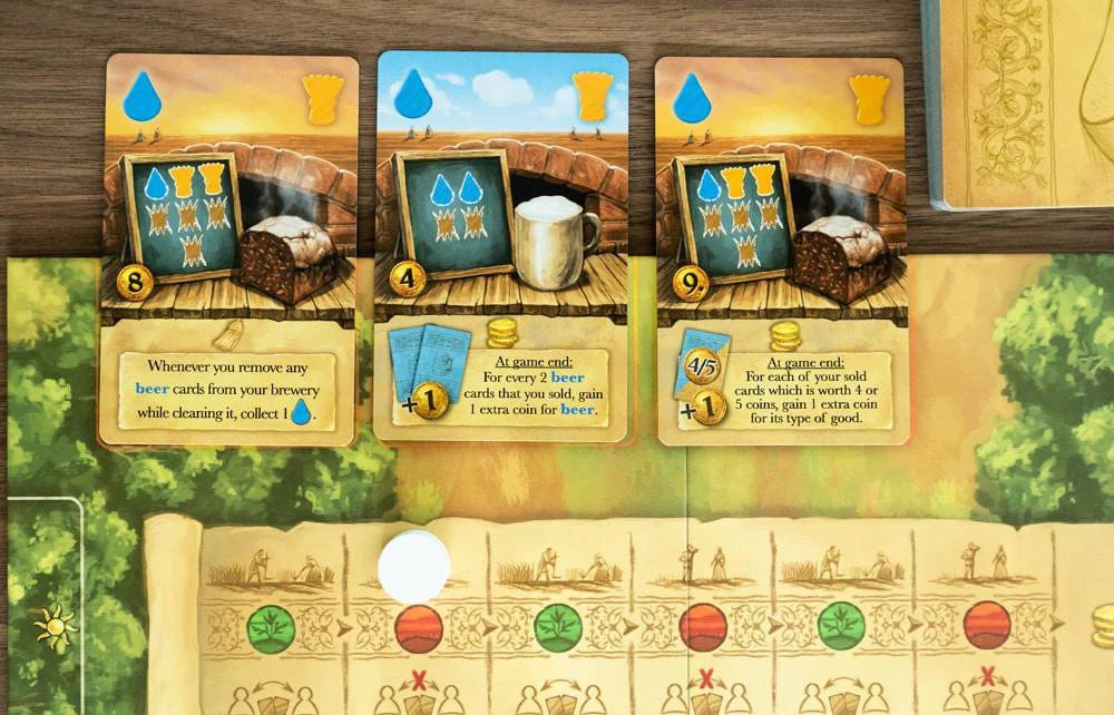 Beer & Bread game cards displayed on a board, showing icons and numbers for resource management.