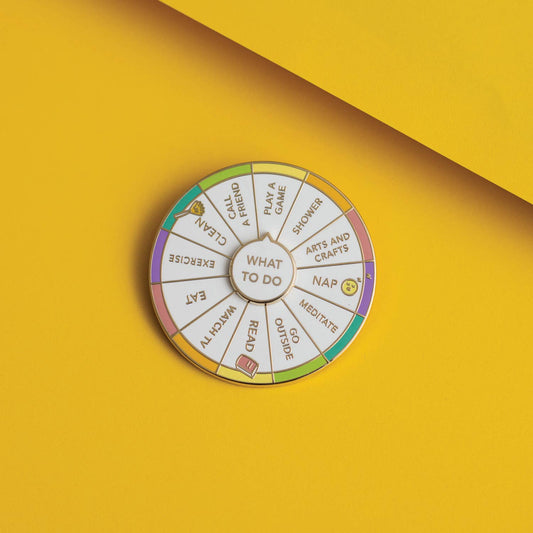 What To Do Spinning Enamel Pin with selectable options: nap, read, exercise, or shower.
