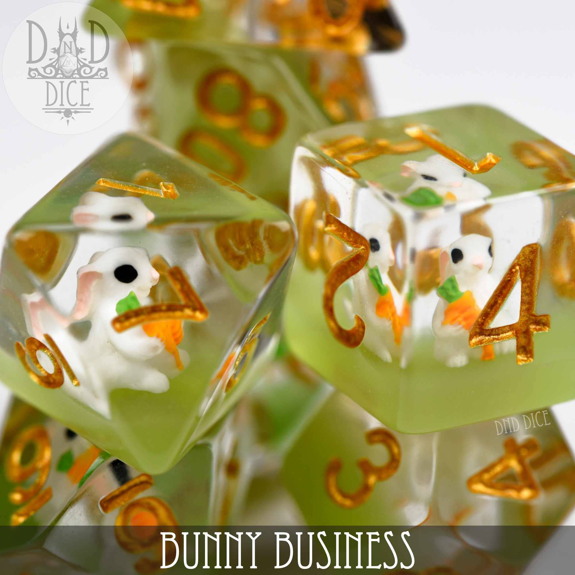 Bunny Business resin dice set with gold numbers and small white bunny figurines inside.