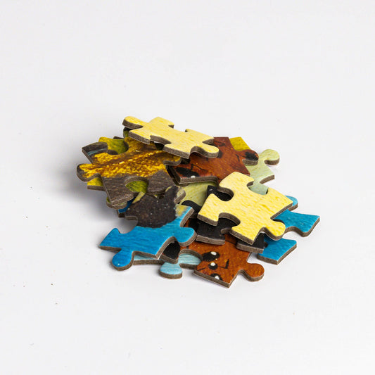 Stack of Puzzle - Salvador Dali - Persistence of Memory pieces on a white background.