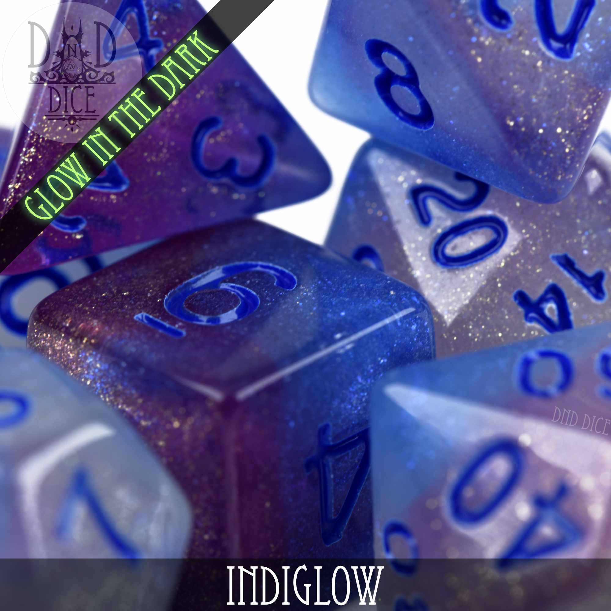 Indiglow Glow in the Dark blue and purple glitter resin DND dice set with blue numbers.