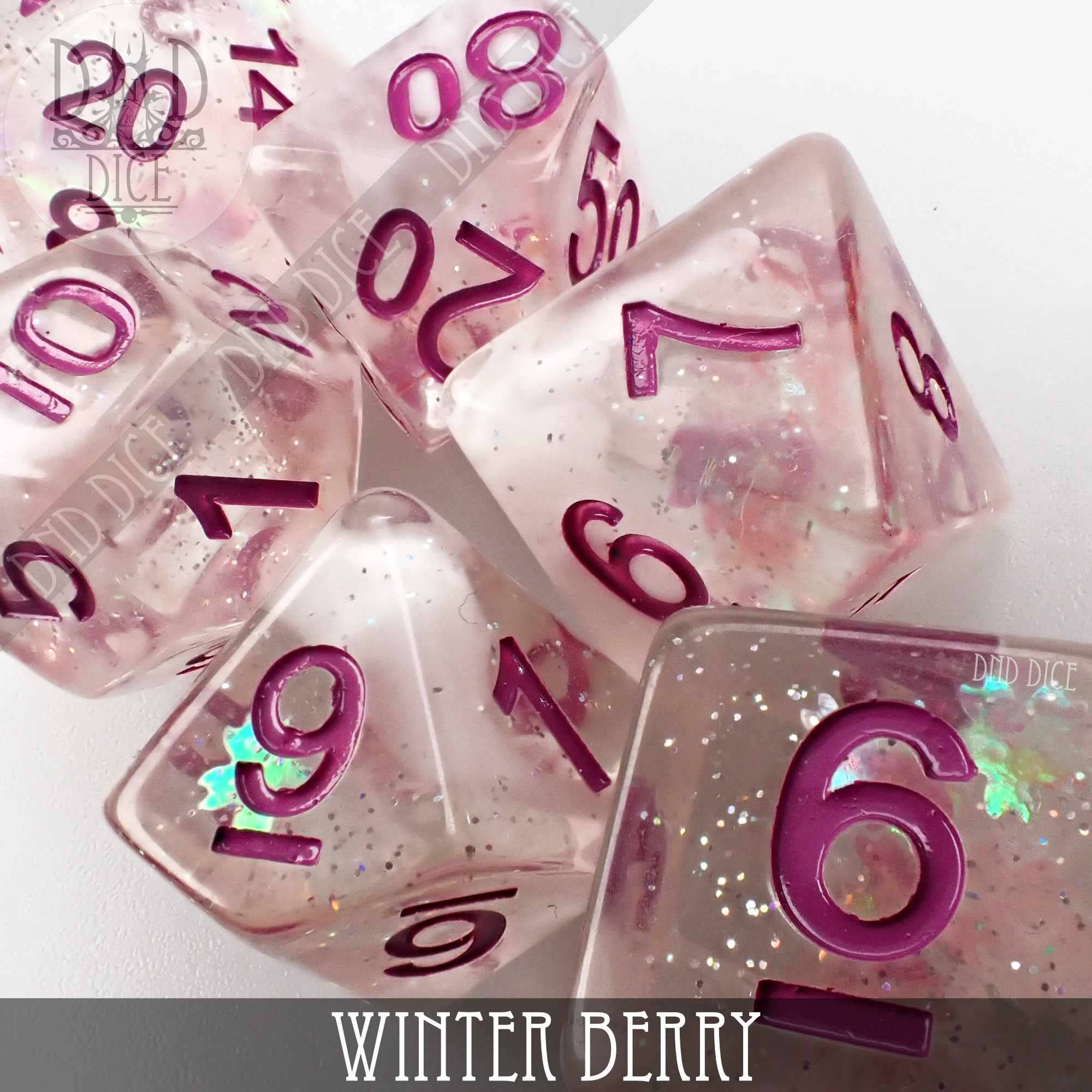 Winter Berry 7-piece set of glittery translucent pink resin dice with berry details and magenta numbers.