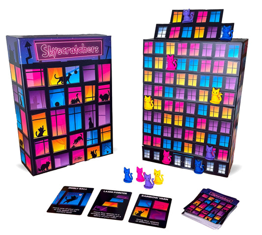 Skyscratchers board game with cat figures and cards featuring cats climbing a building.